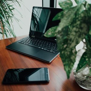 open-laptop-and-cell-phone-on-table (1)